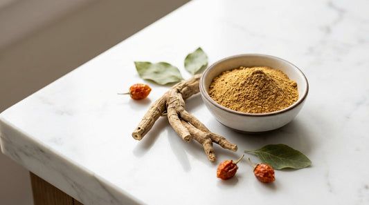 Organic ashwagandha root and powder on white marble surface